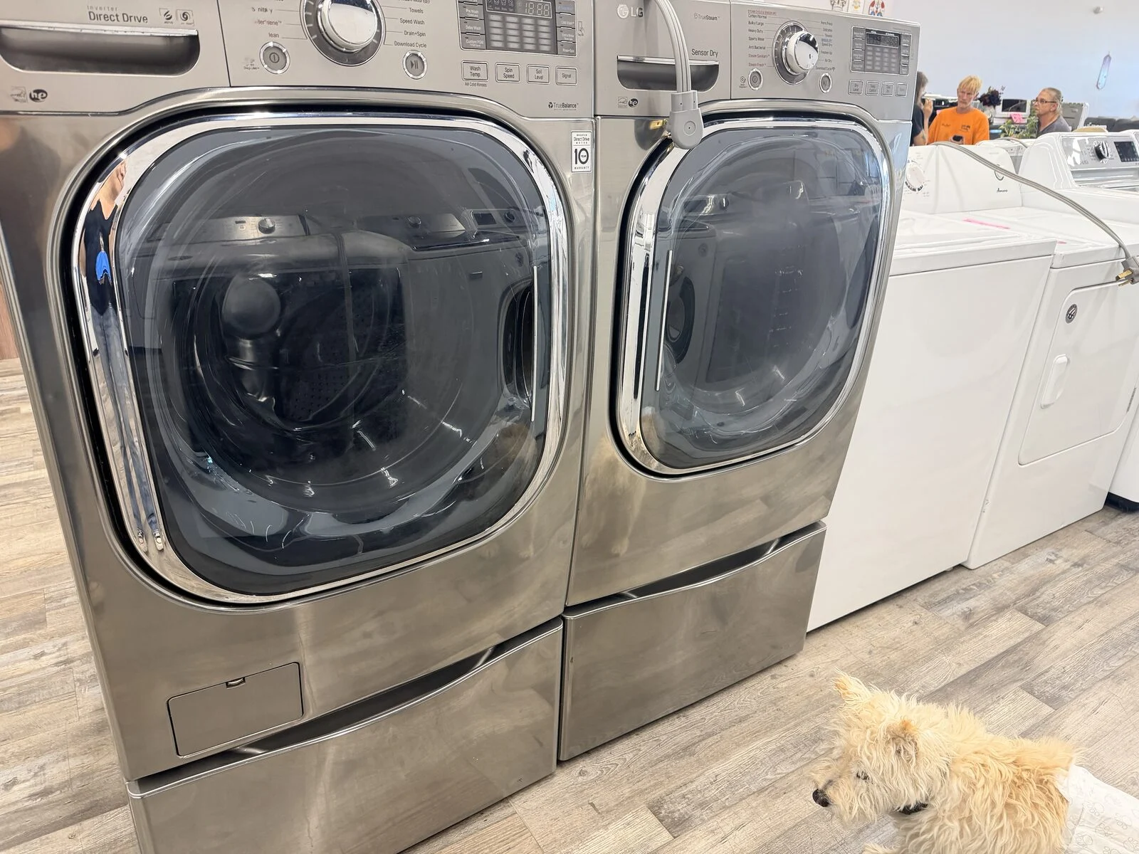 Stainless front-load washer and dryer on pedestals at DT’s Outlet in Wichita