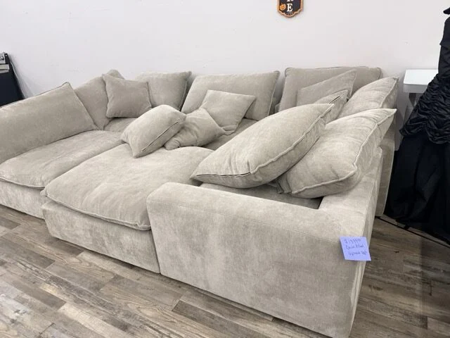 Plush cream cloud-style sectional with chaise and throw pillows at DT's Outlet