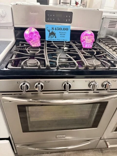 Used Frigidaire stainless steel gas range with price tag at DT's Outlet Wichita