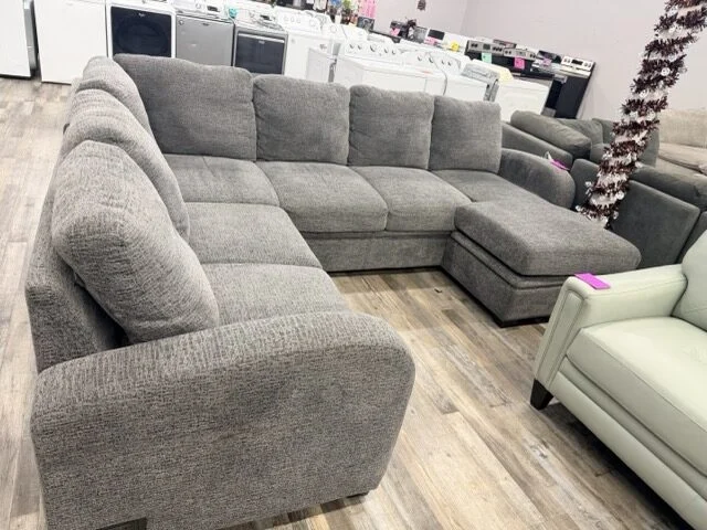 Gray fabric sectional with chaise on the furniture floor at DT's Outlet Wichita