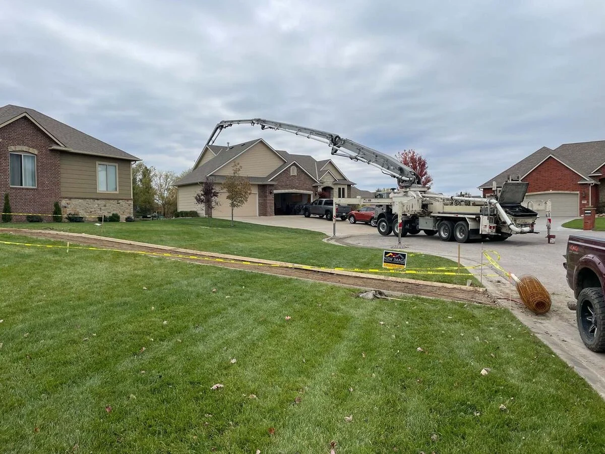 Concrete pump truck placing a residential pour in a Wichita-area neighborhood