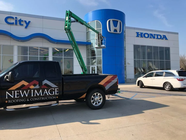 New Image Roofing & Construction truck on a dealership project