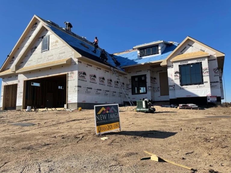 Roofers installing underlayment on a new-construction home