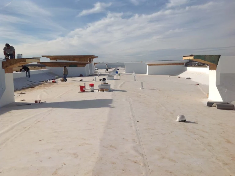 White TPO membrane being installed on a commercial flat roof